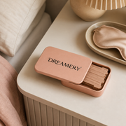 Dreamery Travel Case on a bedside table with sleep mask